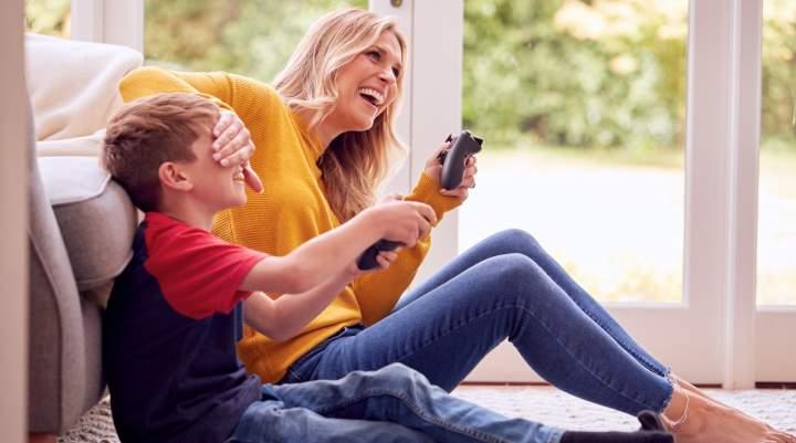 A mum and her son gaming on console together