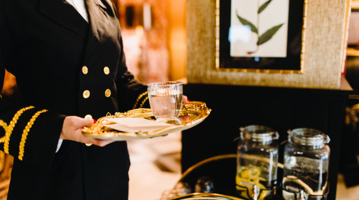 A waiter holding a tray of drinks